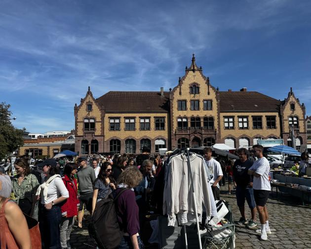 Many people gathered around an older building