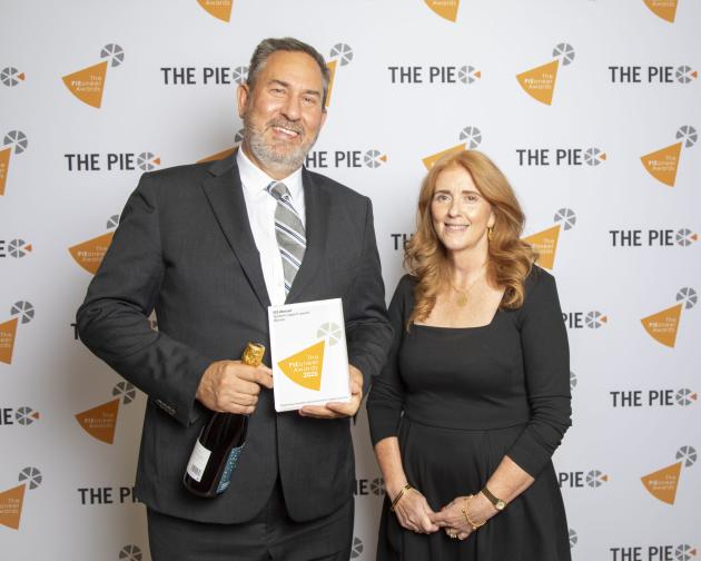 A man holding an award stands beside a woman
