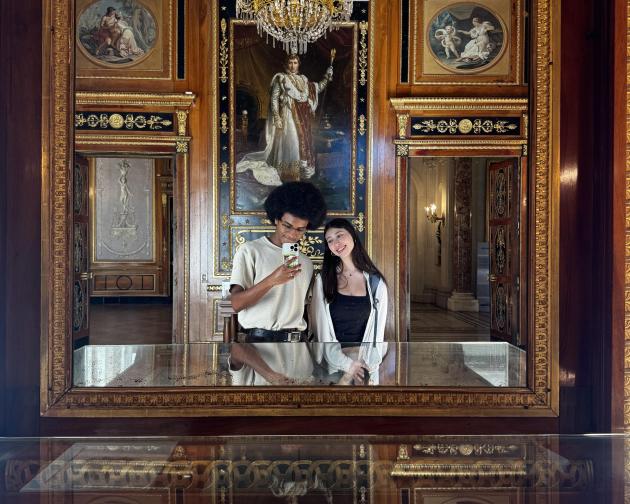 Two people reflected on a mirror