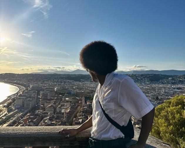Man Standing on Balcony