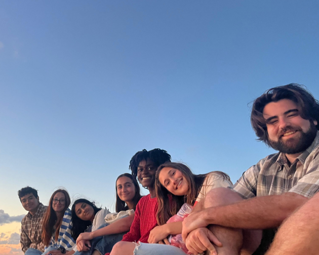 Students smiling in Rabat Morocco in front of a sunset