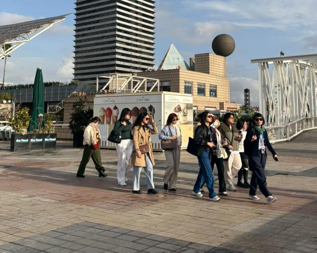 Group of FEU students walking through Barcelona admiring architecture