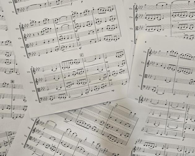A photo of some of the sheet music for my string quartet compositions, sprawled out as if to make a collage.