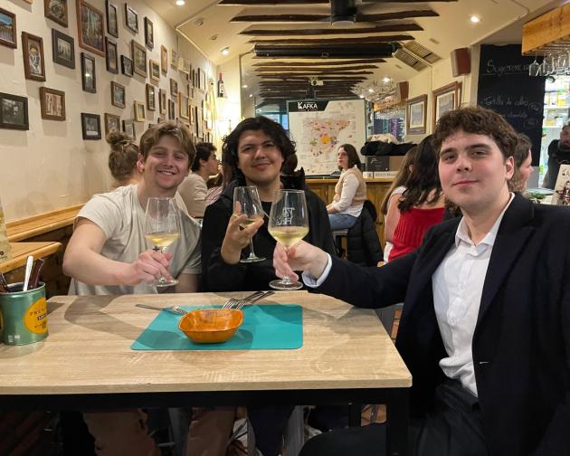 Three guys sitting around a table at a restaurant