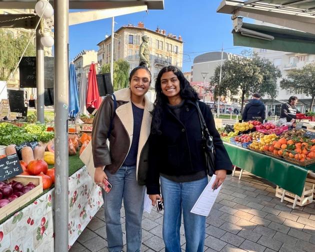 Two students smiling at a market in Nice, France