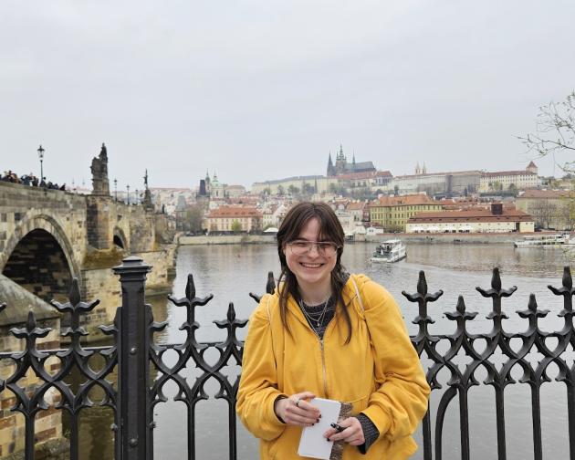 The author stands alone at Charles' Bridge, a famous bridge in Prague, Czechia.