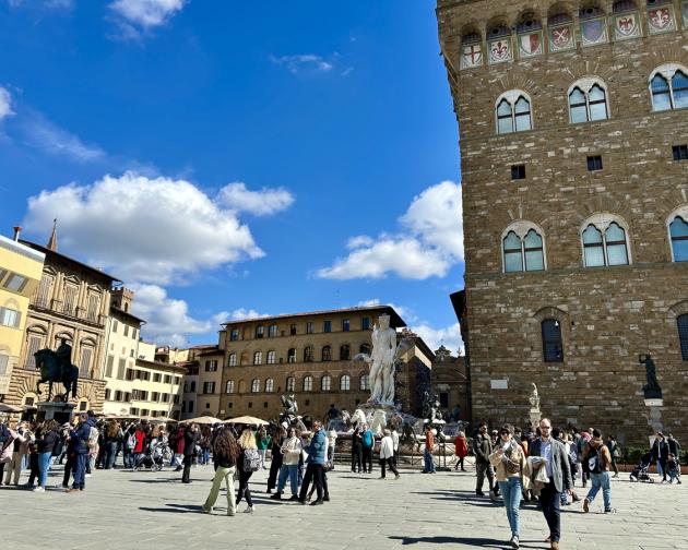Bustling Piazza in Florence with statues and lots of people