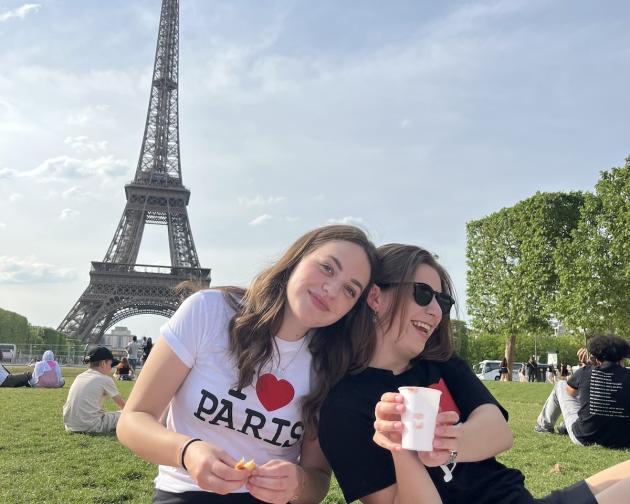 Two students picnicking near the Eiffel Tower in Paris
