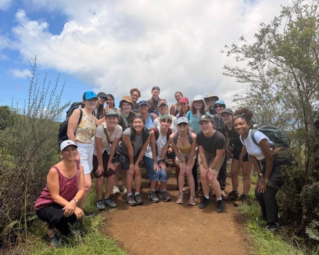 A group of students smiling at the Floreana Island in Quito, Ecuador.