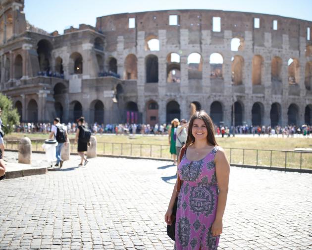 A student next to the Colosseum in Rome, Italy