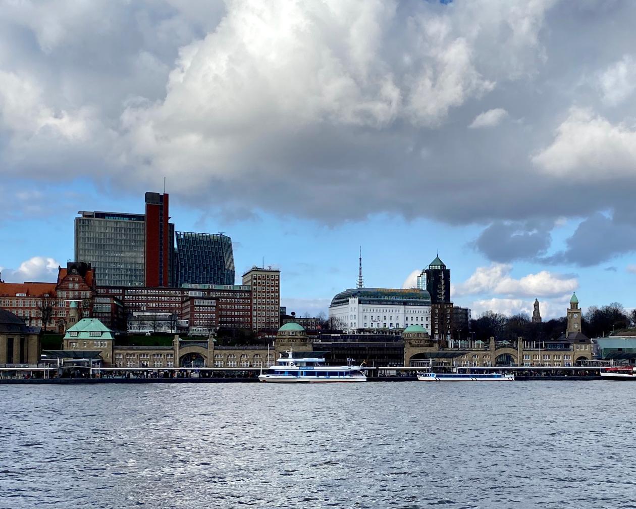 A city sitting off Europe's third largest harbor. The buildings are modern and sleek, with some traditional architecture styles.