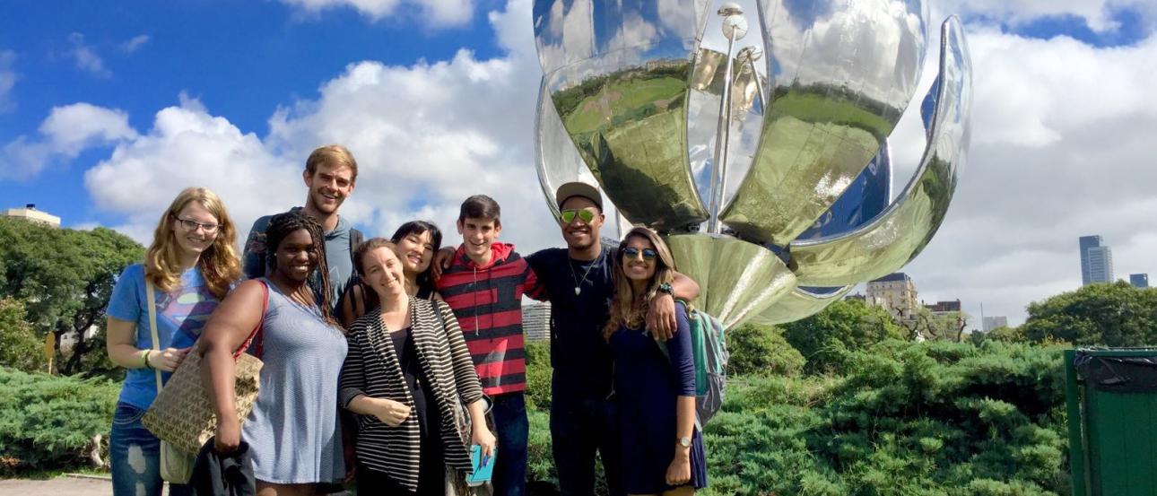 a group of students pose with the Floralis Generica sculpture