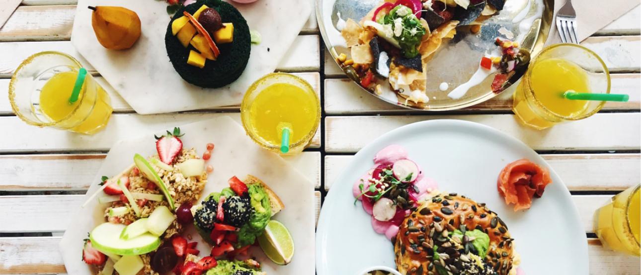 bright colorful foods on many dishes viewed from above