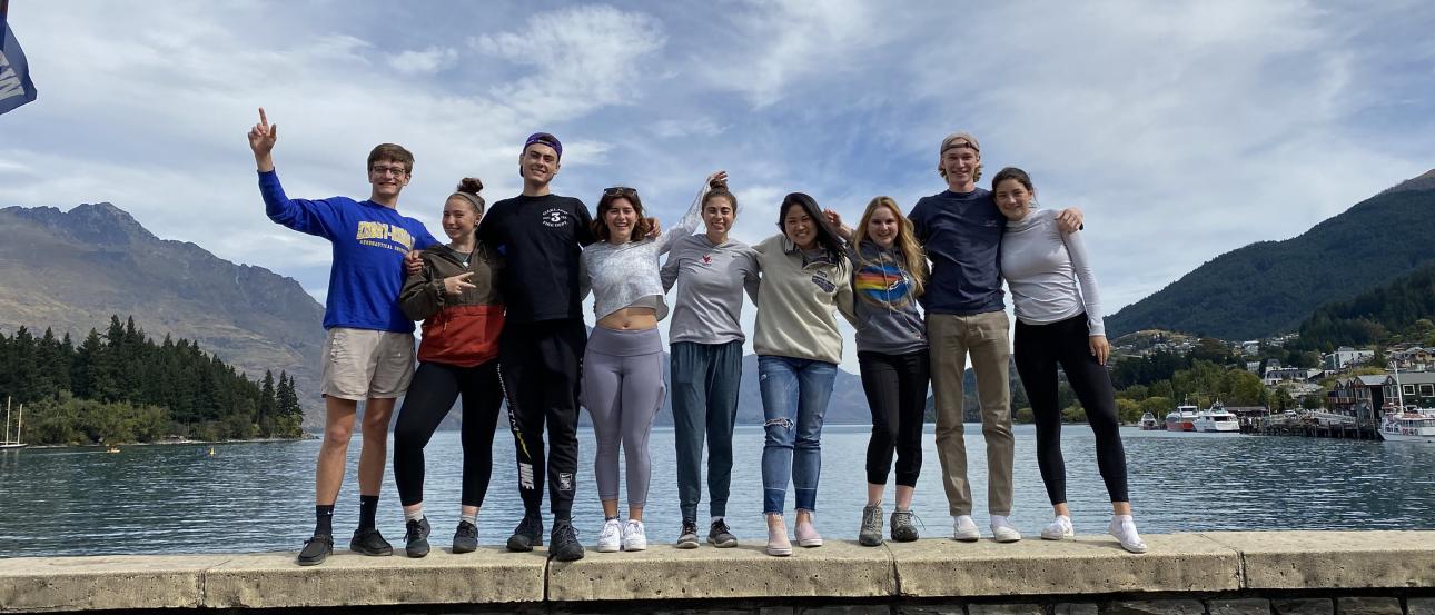 a group of students pose for a lakeside photo in Queenstown