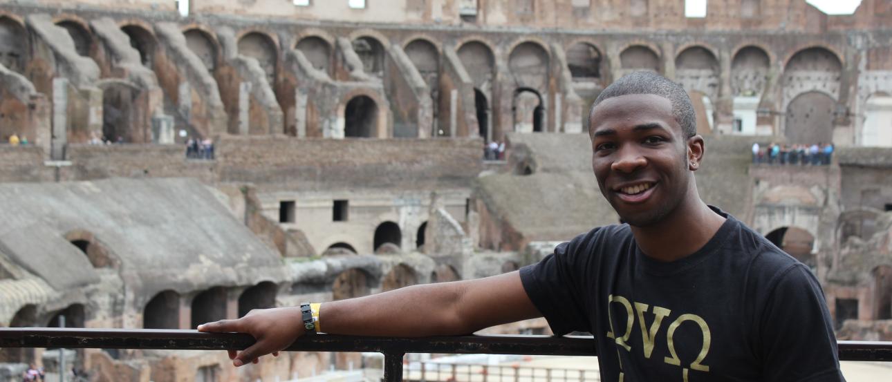 a student poses for a photo inside the Roman Colosseum