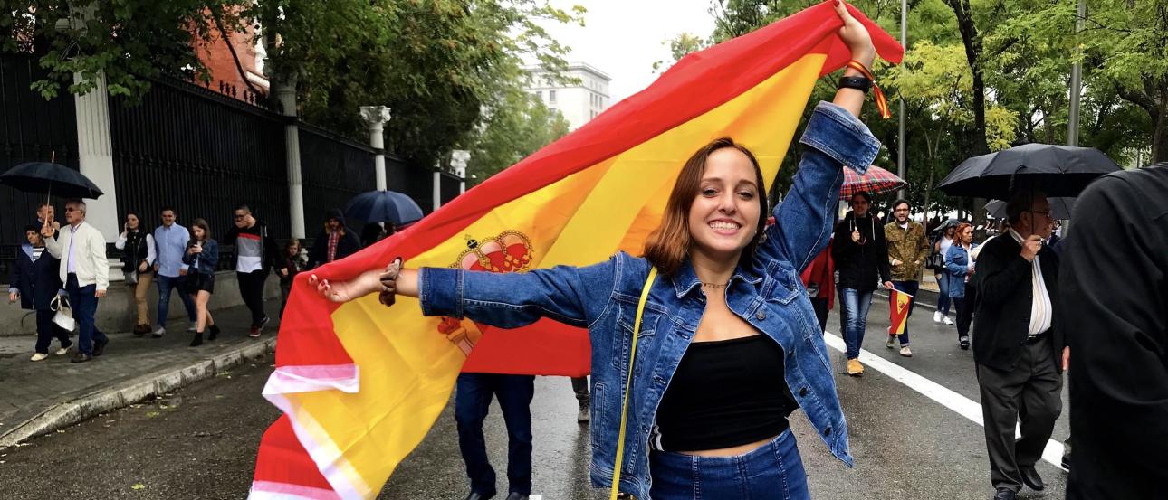 a student holding a Spanish flag to celebrate Dia de la Hispanidad