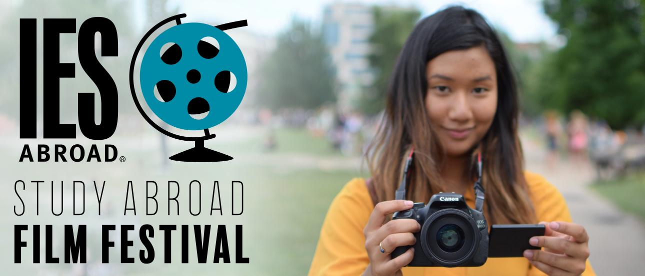 a student smiling while holding a camera next to the IES Abroad Study Abroad Film Festival logo