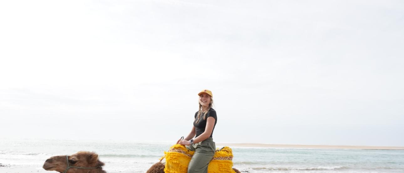 Nina Pollak riding a camel off the coast of Asilah, Morocco!