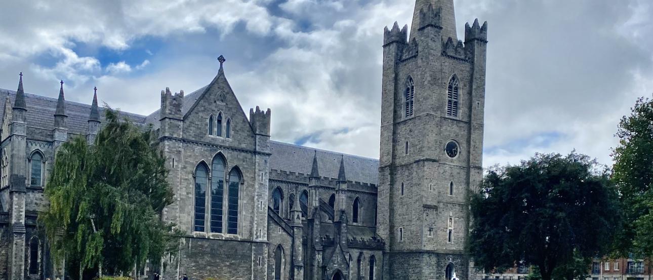 A photo of the fountain and lawn in St. Patrick’s Park with St. Patrick’s Cathedral in the background.