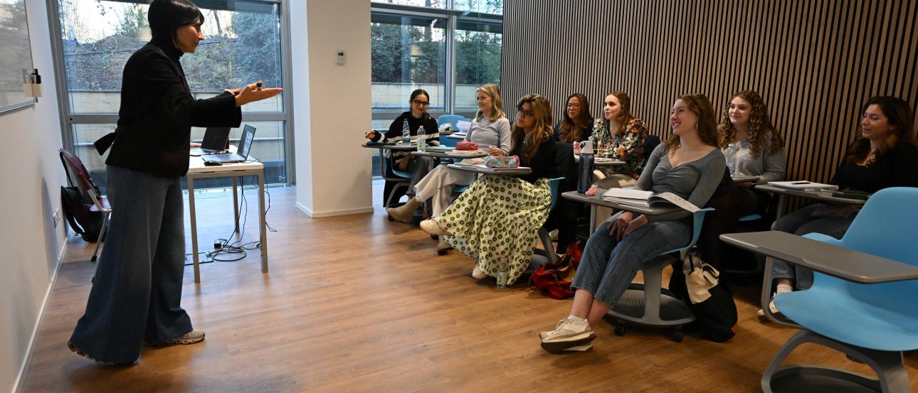 Professor teaching a group of students in a classroom