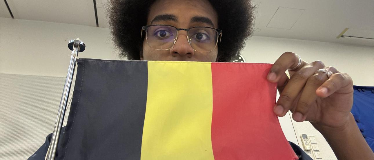 Man holding up Belgium flag