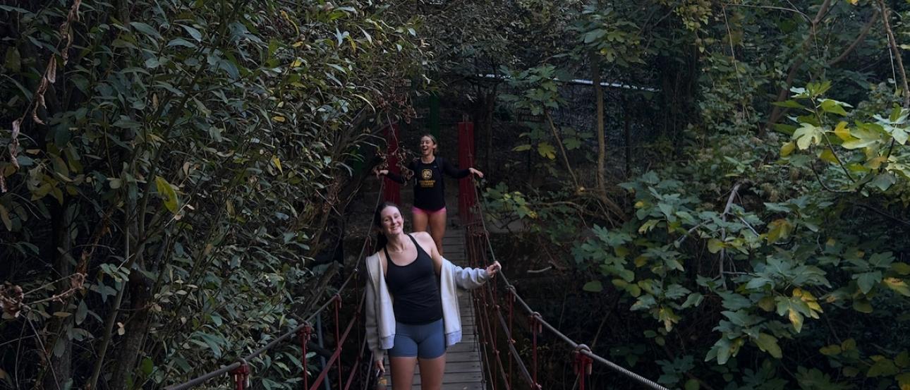 Molly and I smiling on the red wooden bridge at Cahorros de Monachil