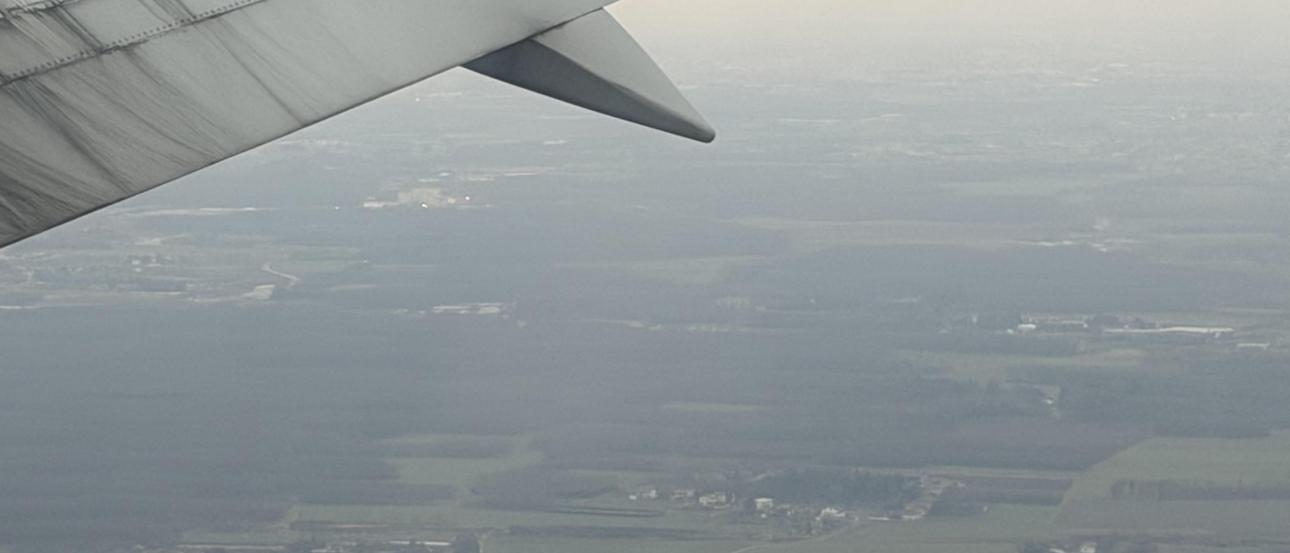 A photo from the window of a plane showing a vast city. 