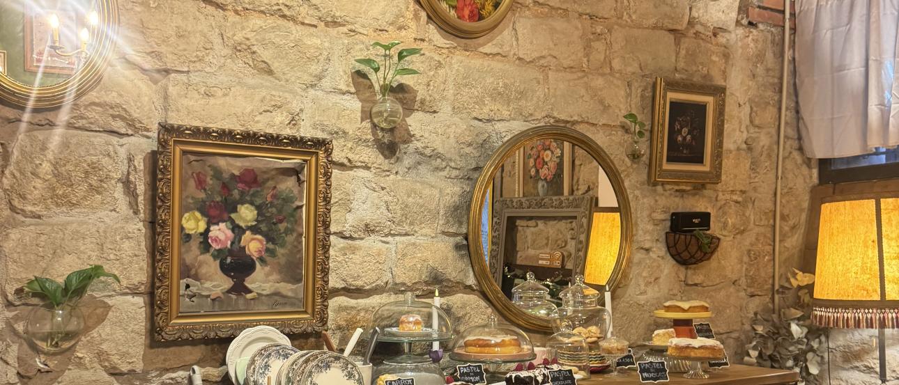 Brick wall of a cafe interior decorated with picture frames and knicknacks