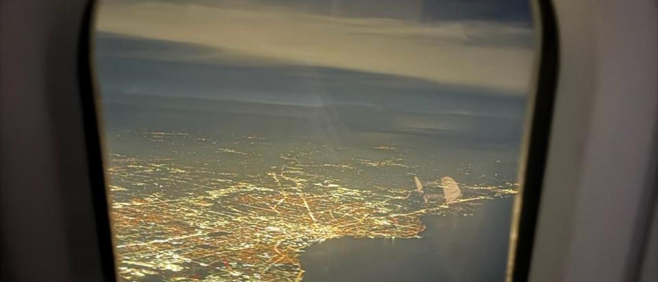 The nighttime cityscape of Chicago from a plane window.