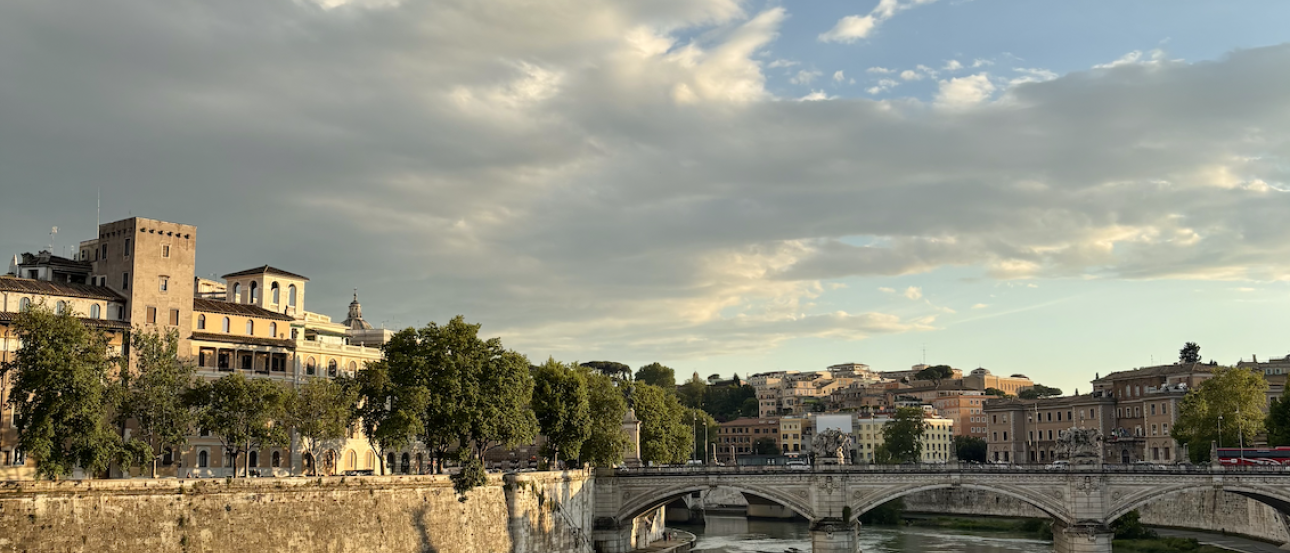A view of Rome's historical buildings against the blue Tiber River