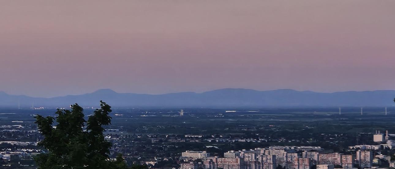 A view from Kahlenberg over Vienna with a beautiful sunset painting the sky a gentle red.