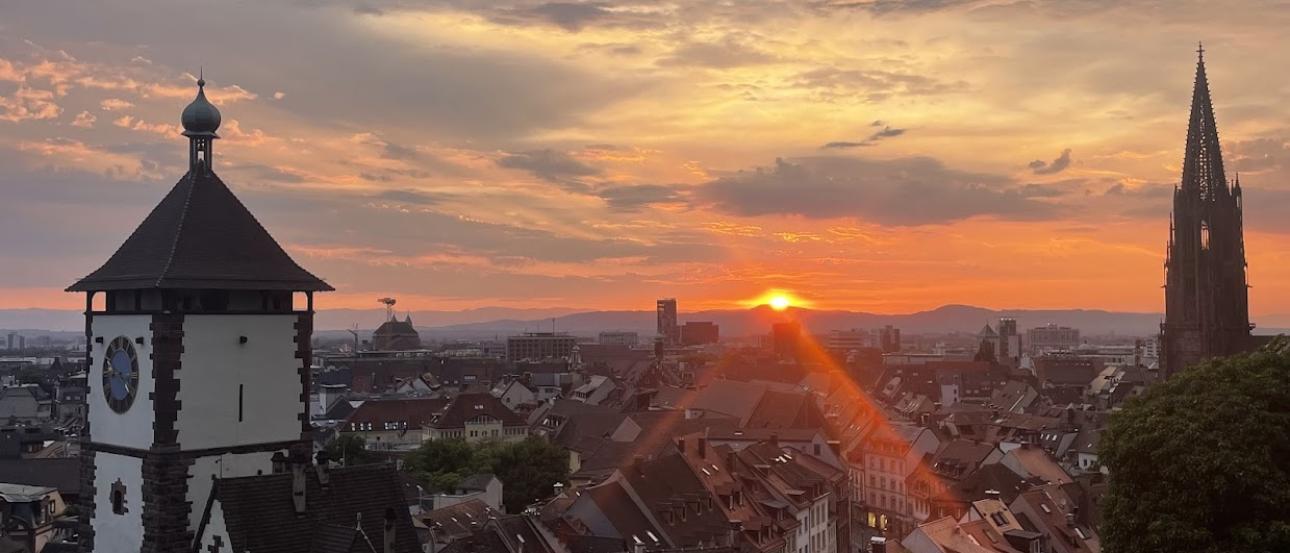 Sunset in Freiburg, the Munster and Schwabentor are visible
