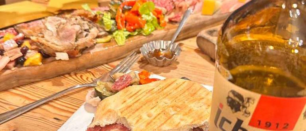 cutting board, ichnusa, and a proscuitt sandwich