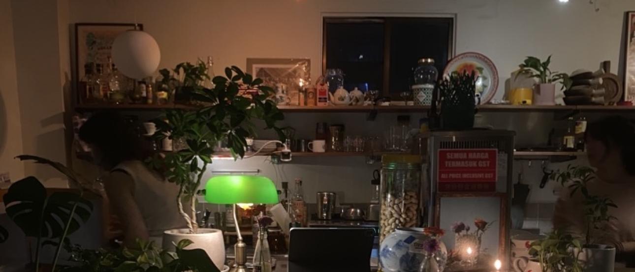 A low-lit image of a bar at a restaurant I was eating dinner at. Most of the light is emitting from a green lamp.