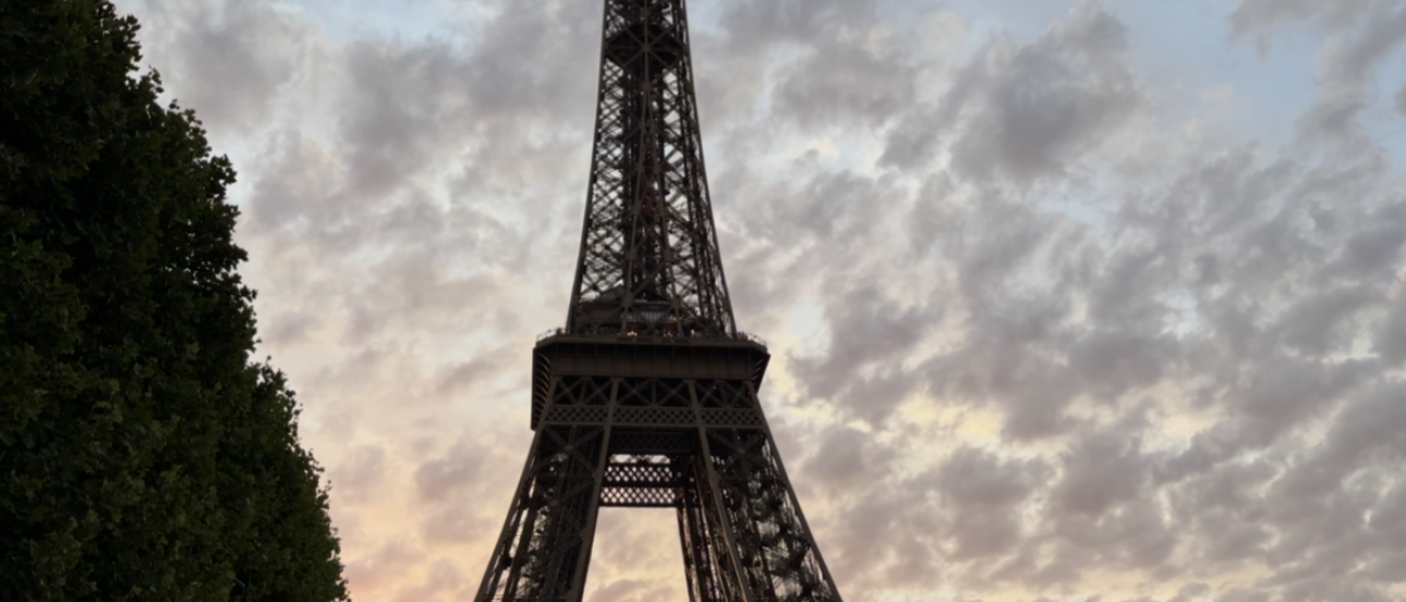 A silhouette of the Eiffel Tower in front of an orange sunset