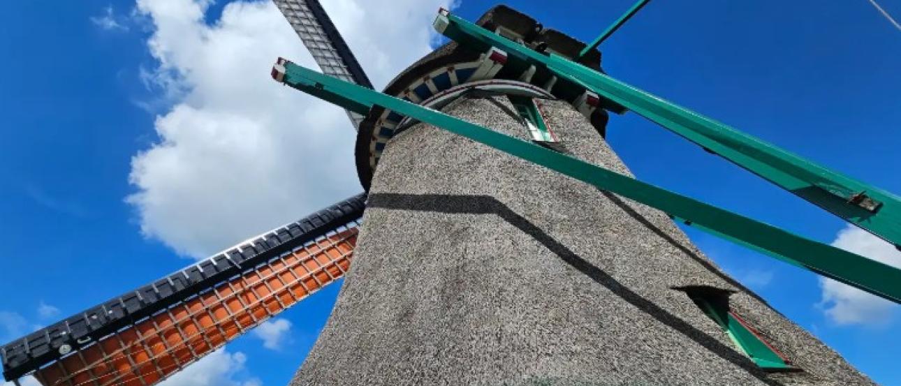An upward capture of a Zaanse Schans windmill from its base. 