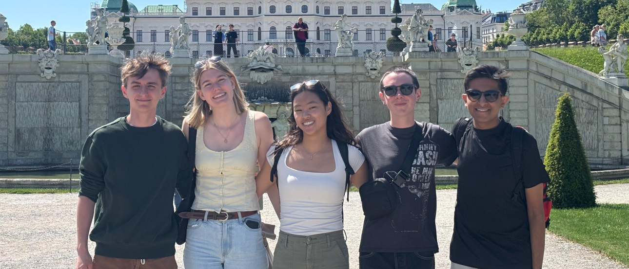 Classmates posing in front of Belvedere Palace in Vienna, Austria