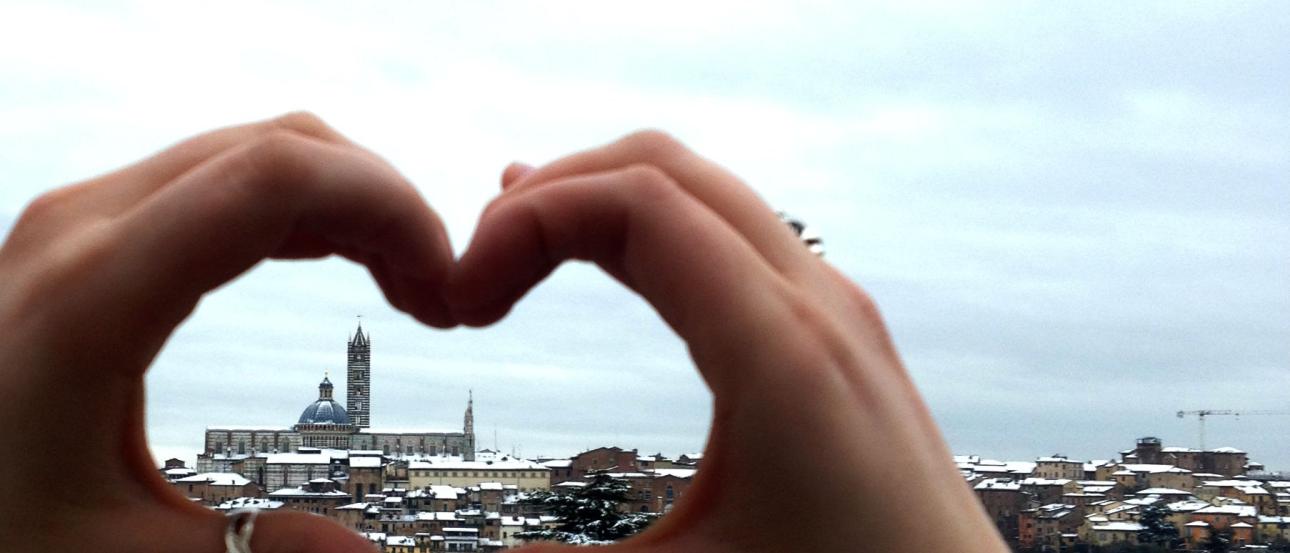 Moody Paris skyline with Eiffel Tower under cloudy skies.

Wide beach view with distant railway bridge under blue sky.

Hands forming heart shape overlooking a cityscape. This alt text was added with Al; accuracy may vary.