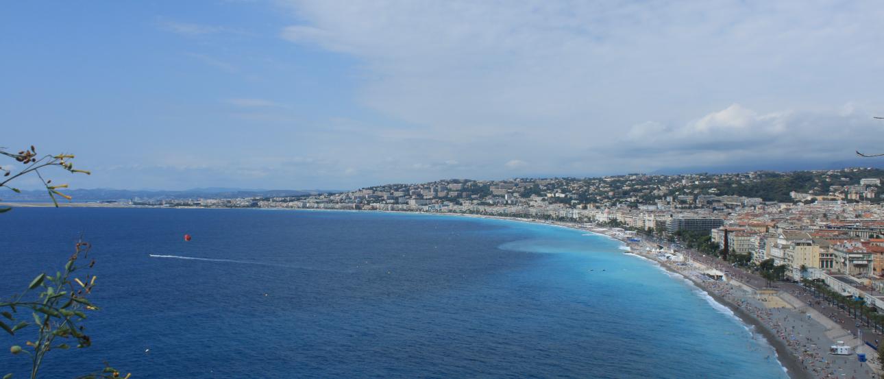White candle and "Anna Karenina" book on a cozy table setting. This alt text was added with Al; accuracy may vary.