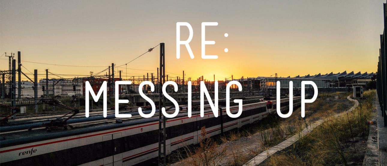 Train tracks at sunset with silhouette of overhead wires. This alt text was added with Al; accuracy may vary.