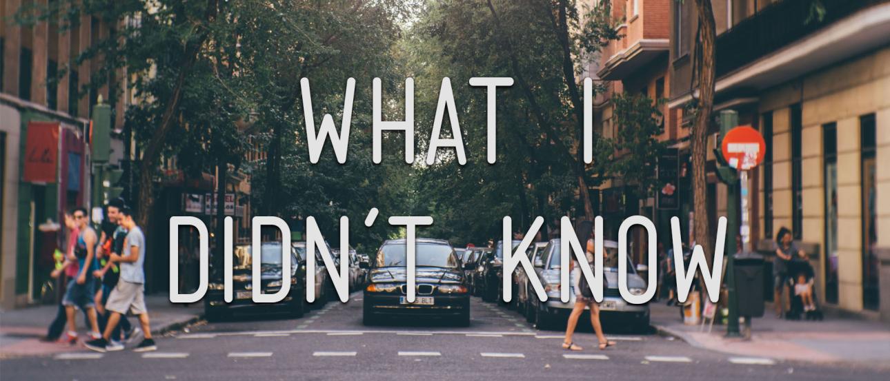 A street with people crossing, trees, and parked cars. This alt text was added with Al; accuracy may vary.