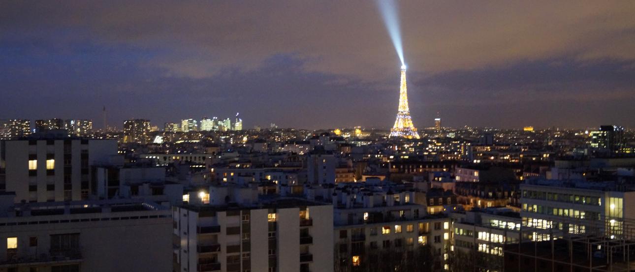 Cityscape with the Eiffel Tower illuminated at night. This alt text was added with Al; accuracy may vary.