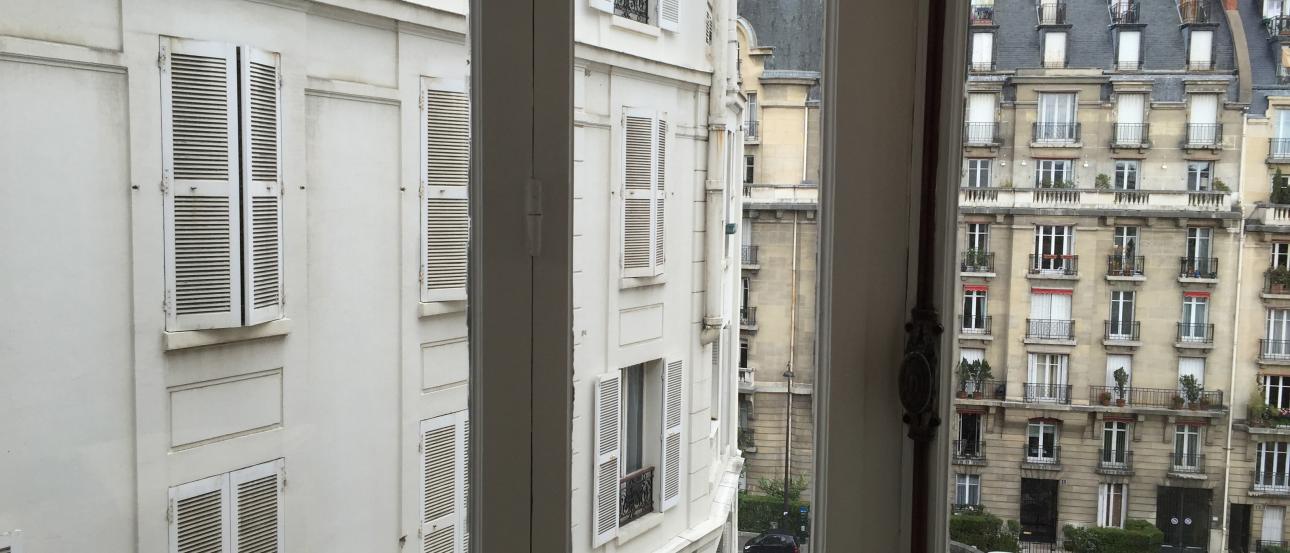 Cup raised in a Paris street café setting. This alt text was added with Al; accuracy may vary.