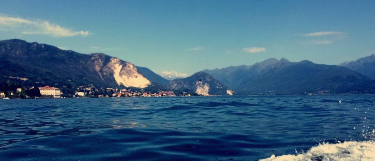 Scenic view of a lake with mountains in the background under a clear blue sky. This alt text was added with Al; accuracy may vary.