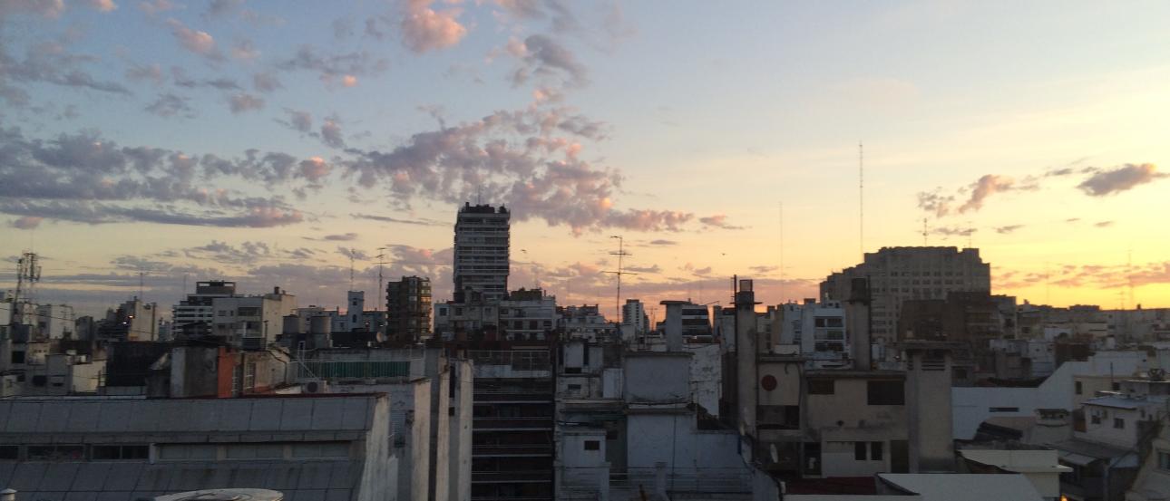 Skyscrapers and rooftops at sunset in Buenos Aires. This alt text was added with Al; accuracy may vary.