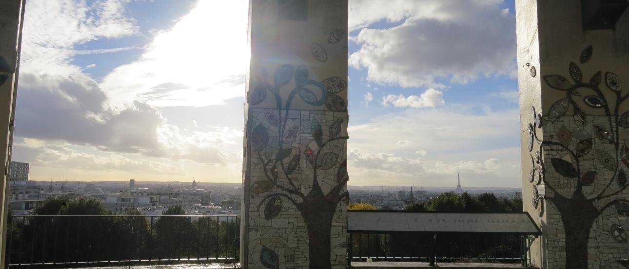 1. View of Paris through an archway at dusk.
2. Ferris wheel and Eiffel Tower silhouetted at sunset.
3. Narrow Parisian street at sunset.
4. Sunlight and clouds seen through a graffiti-lined columned archway. This alt text was added with Al; accuracy may vary.