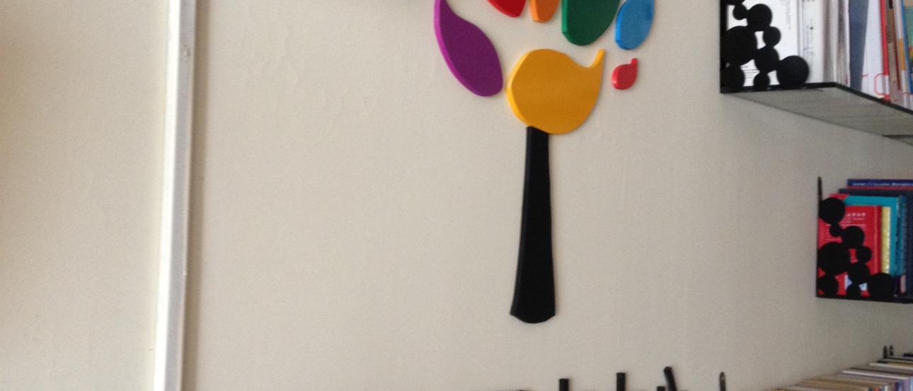 Beach with two people walking along a rocky shore, under a cloudy sky. This alt text was added with Al; accuracy may vary.