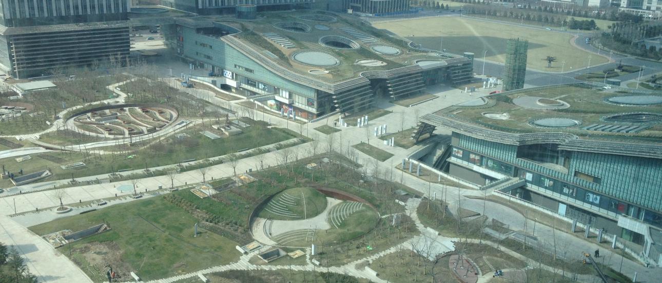 Colorful tower lit at night near a waterway. This alt text was added with Al; accuracy may vary.