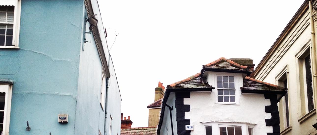 Narrow street with colorful buildings and small shops. 