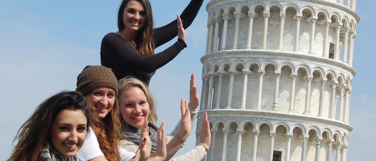 Crowded subway platform with arrow exit sign. This alt text was added with Al; accuracy may vary.